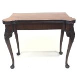 A George II mahogany concertina card table, the shaped top opening to reveal a baize lined interior,