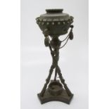 An unusual oil lamp, the chimney a castellated design strung with decorative hand grenades, the