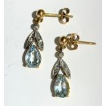 A pair of earrings, set with pear shaped aquamarine and small diamonds.