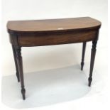 A 19th century mahogany fold-over card table, with turned tapering legs. (Dimensions: Height 73cm,