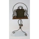A Victorian Aesthetic Movement brass and oak magazine stand, the swivelling upper section with two