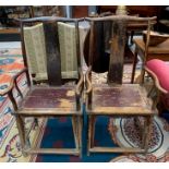 A pair of Chinese hardwood armchairs, early 19th century, the shaped top rail and central vertical