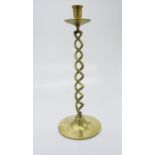 A large brass candlestick with twisted stem. (Dimensions: Height 48cm.)(Height 48cm.)