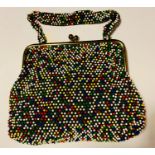 Candy dot beaded purse by Lumured of Fifth Avenue. Gilt metal frame and clasp. Black silk lining.