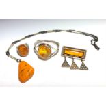 An amber set silver bracelet, an amber and silver ring, a necklace with a large amber drop and an