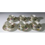 Six Dresden coffee cans and saucers with polychrome floral and gilt decoration.