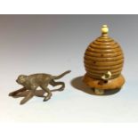 A novelty vegetable ivory tape measure in the form of a skep, together with a cold coloured metal