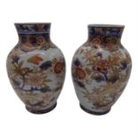 A pair of Japanese Imari porcelain baluster vases, late 19th century, decorated with birds amongst