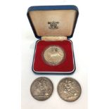 An 1977 proof crown cased and two Victorian crowns.