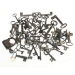 A large collection of antique keys and an old padlock in one box.