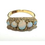 A 9ct gold ring set five opals.