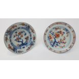 A pair of Chinese Imari porcelain plates, 18th century, both decorated with flowering trees. (