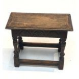 An oak joint stool, the carved frieze on turned and block legs joined by stretchers. (Dimensions: