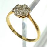 An 18ct. gold ring set a flower head diamond cluster