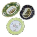 A Rockingham teacup and saucer, circa 1830 - 41, two Derby dishes decorated with topographical