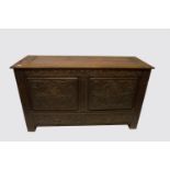 A Victorian carved oak mule chest, the hinged top above two drawers craved with grotesque masks,
