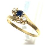 A sapphire and diamond three stone crossover ring