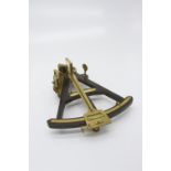 A 19th century brass, ebony and ivory navigational octant, the scale divided to 100 degrees,