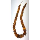 An amber necklace consisting of graduated pebble shaped beads, length 49cm.