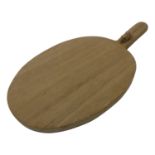 A Thompson of Kilburn 'Mouseman' oak cheeseboard of oval form, with carved mouse signature to raised