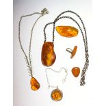 Three amber necklaces, the largest pendant 6.9 x 3.9cm, an amber pendant, an amber ring and an amber