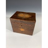 A George III mahogany tea caddy, with oval inlaid patera panels, the cover opening to reveal two