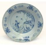 An English Delft bowl, 18th century, decorated with a figure in a garden. (Dimensions: Diameter