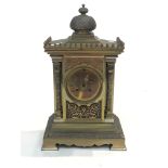 A French late 19th century mantel clock, the cast and engraved brass case of architectural form,