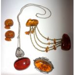 A pair of amber cufflinks, a silver and amber necklace and two amber brooches.