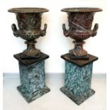 A pair of Victorian cast iron campana garden urns, with faux serpentine decoration, each on