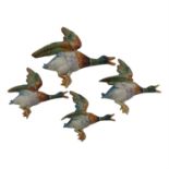 A graduated set of four Royal Dux flying mallard ducks. (Dimensions: Largest 31cm long.)(Largest