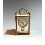 A Swiss mother of pearl cased miniature carriage clock with heart shaped lenticle, leather case. (