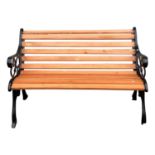 A black painted cast iron garden bench, with replacement wooden slats.