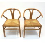 A pair of ash rush seated armchairs, 20th century, each with a curved top rail.
