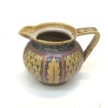 A 19th century continental Majolica jug with hand painted decoration. (Dimensions: Height 16.5cm