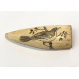 A 19th century scrimshaw whale tooth, inscribed 'Bird of Nantucket 1868', the finely engraved bird
