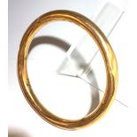 A 9ct gold bangle, 18gm.