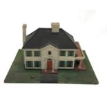 A model of a plantation colonial style house, circa 1920s, with clapperboard finish, shuttered