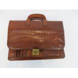An Origo brown leather briefcase with crocodile effect pattern.