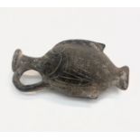 An ancient flask in the form of a fish, in unglazed black pottery, possibly Roman. (Dimensions: