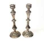 A pair of filled silver candle sticks with acanthus decoration, height 26.5cm