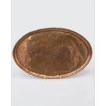 An Arts and Crafts period Hugh Wallis oval copper tray with central floral decoration, stamped