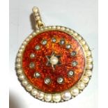 An Edwardian discus pendant with a crescent of pearls around a red enamel guilloche field set with a