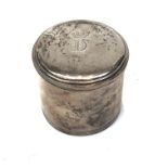 A small cylindrical silver toilet pot, the lid engraved with a crown over the letter 'D'.