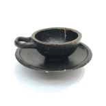 An ancient Greek cup and stand, black glazed Campanian type, with loop handle. (Dimensions: Diameter