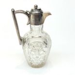 A late Victorian silver and cut glass claret jug, the silver collar engraved with the motto 'Nec