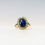 A blue stone and diamond oval cluster ring.Condition report: Size M/N Blue stone not known but