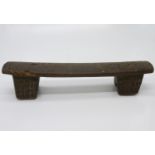 A late 19th/early 20th century African Zulu headrest, on two block feet. (Dimensions: Wiidth