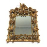 A Victorian giltwood wall mirror, carved with flowers, grapes and leaves. (Dimensions: Height