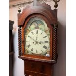 An early 19th century mahogany eight day longcase clock, with a painted rolling moon arched dial